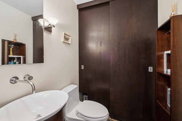 bathroom featuring toilet and a sink