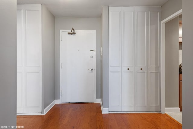 interior space featuring baseboards and light wood-type flooring