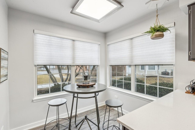 dining space featuring baseboards and wood finished floors