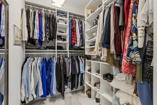 spacious closet featuring marble finish floor