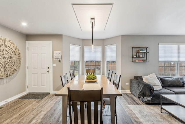 dining room featuring baseboards and wood finished floors