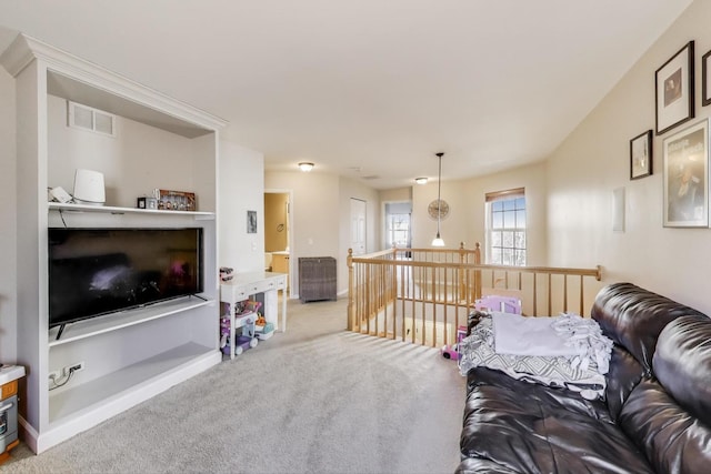 living room with carpet, visible vents, and baseboards