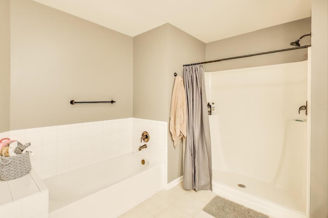 full bath with a garden tub, a shower stall, and tile patterned flooring