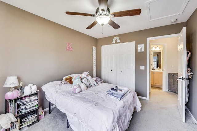 bedroom with attic access, baseboards, a ceiling fan, light colored carpet, and a closet