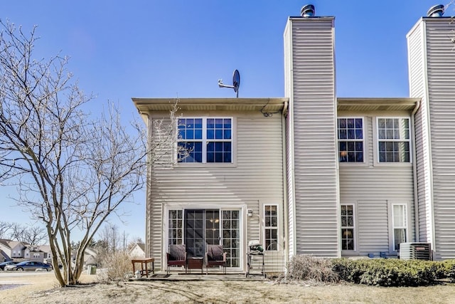 rear view of property featuring a chimney