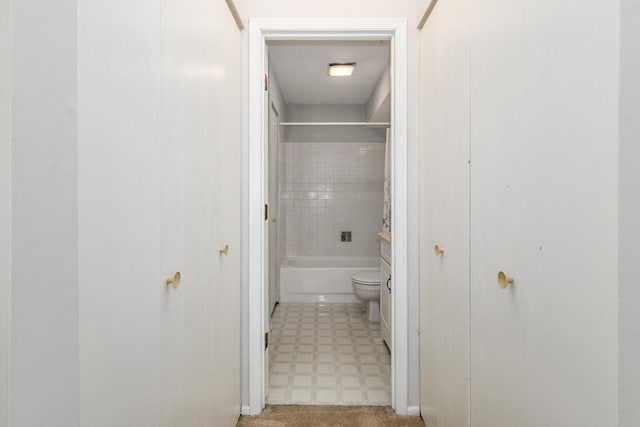 bathroom featuring toilet, bathtub / shower combination, and tile patterned floors