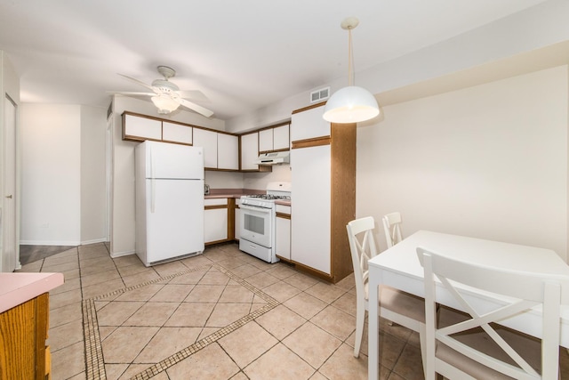 kitchen featuring white appliances, light tile patterned floors, visible vents, under cabinet range hood, and white cabinetry