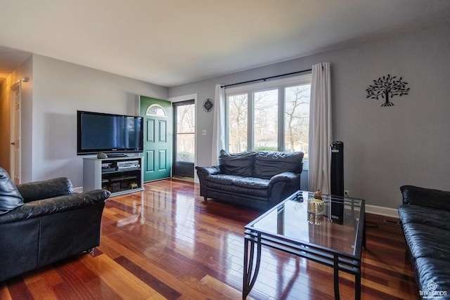 living room featuring wood finished floors and baseboards