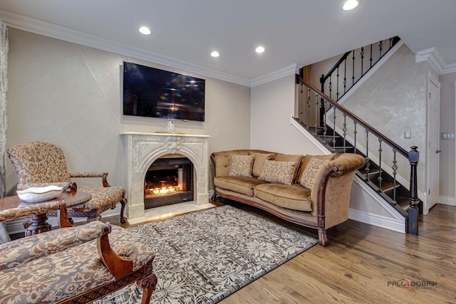 living room with stairs, ornamental molding, wood finished floors, and recessed lighting