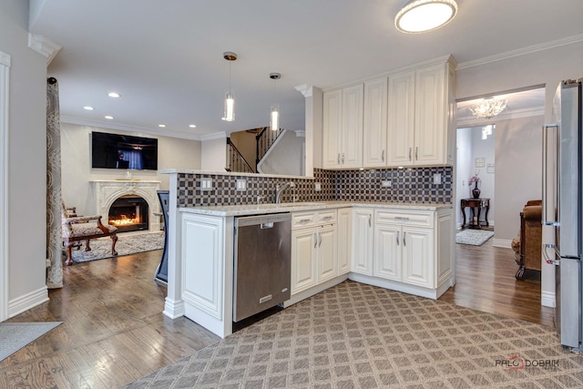 kitchen featuring light wood finished floors, decorative backsplash, appliances with stainless steel finishes, open floor plan, and crown molding