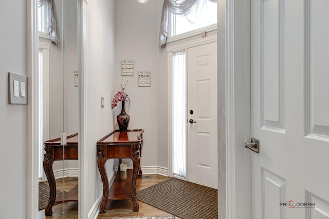 foyer with wood finished floors and baseboards