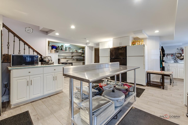 kitchen featuring freestanding refrigerator, white cabinetry, and recessed lighting