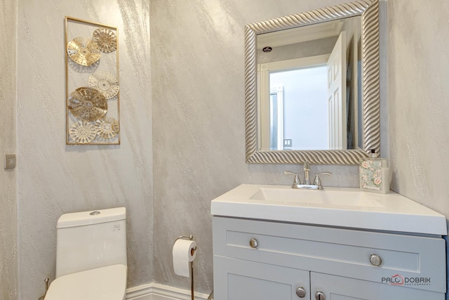 bathroom featuring vanity and toilet