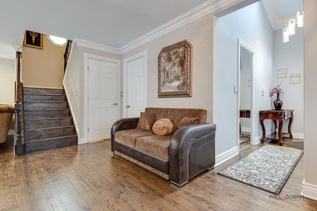 sitting room with ornamental molding, stairs, baseboards, and wood finished floors