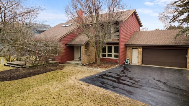 view of front of property with a balcony, a garage, a shingled roof, driveway, and a chimney