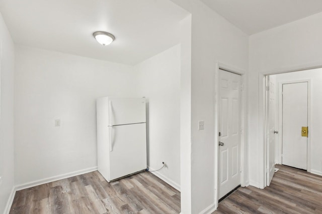 interior space featuring baseboards and wood finished floors