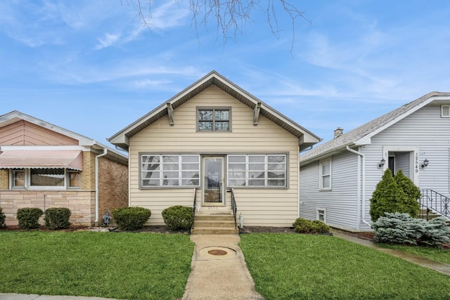 bungalow-style house with a front yard