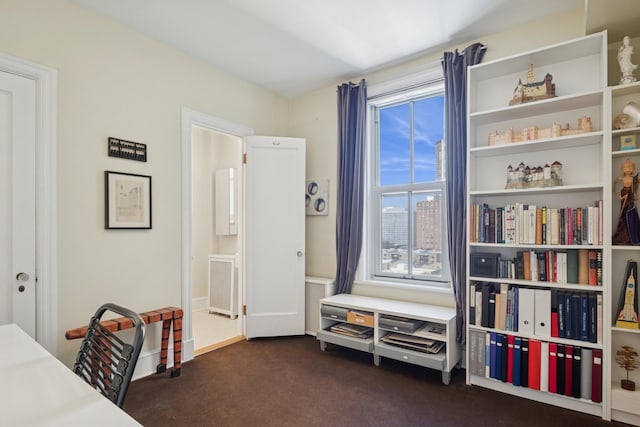 office area with baseboards and dark carpet