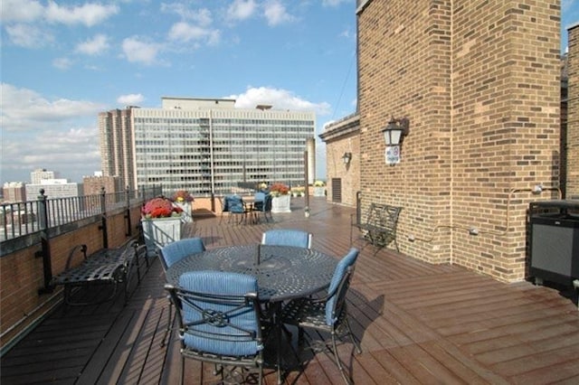 wooden deck featuring outdoor dining space