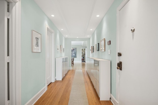 corridor with baseboards, recessed lighting, and light wood-style floors