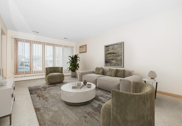 carpeted living area featuring a wall unit AC, a baseboard heating unit, baseboards, and visible vents