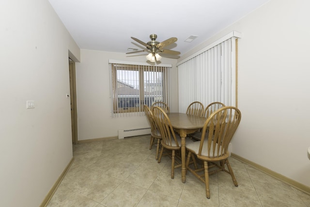 dining space with a baseboard heating unit, ceiling fan, light tile patterned flooring, and baseboards