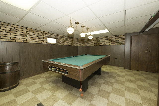 rec room featuring light floors, billiards, a paneled ceiling, and wooden walls