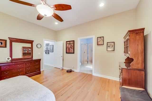 bedroom featuring recessed lighting, baseboards, light wood-style floors, and ensuite bath