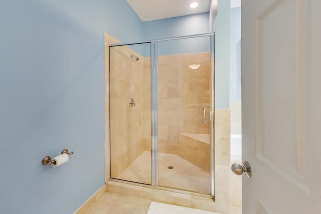 full bath featuring a shower stall and tile patterned flooring