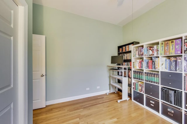 interior space with baseboards and wood finished floors