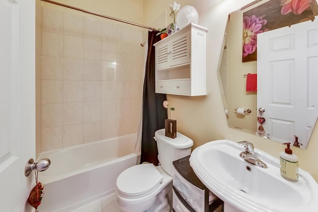 bathroom featuring toilet, shower / bathtub combination with curtain, and a sink