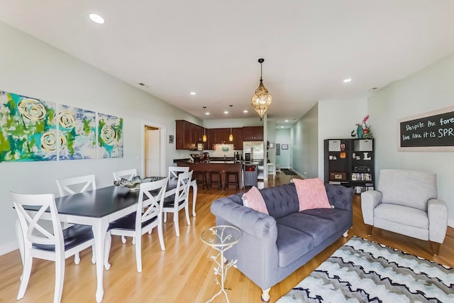 living room with light wood finished floors and recessed lighting