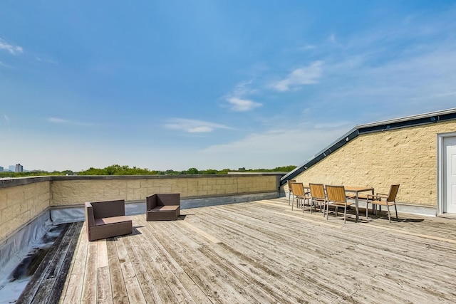 wooden terrace with outdoor dining space