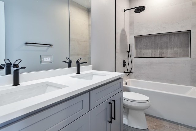 full bathroom with double vanity, shower / bath combination, a sink, and toilet