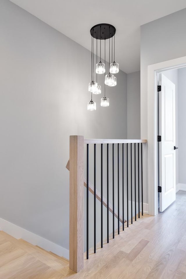 stairs featuring wood finished floors and baseboards