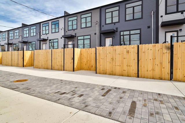 view of front facade with a residential view and fence