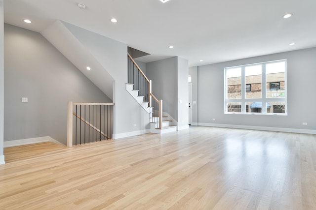 spare room featuring baseboards, recessed lighting, and light wood-style floors