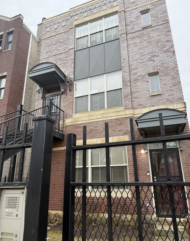 exterior space with brick siding and fence