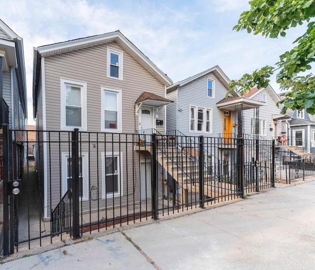 view of front facade featuring a fenced front yard and a residential view