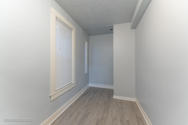 1932 W 22nd Pl, Chicago, IL 60608 - interior space featuring a textured ceiling, wood finished floors, and baseboards