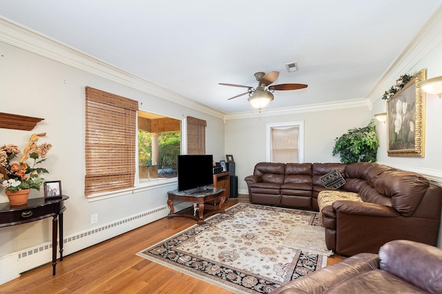 living area featuring crown molding, visible vents, ceiling fan, wood finished floors, and baseboards