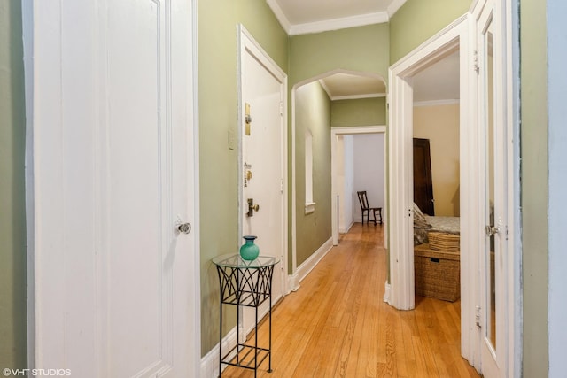 hall featuring light wood-style floors and crown molding