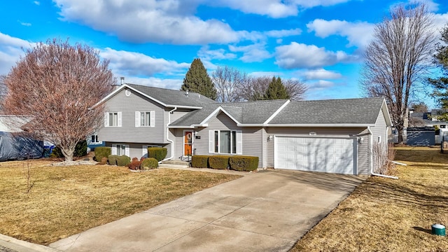 split level home featuring driveway, a front lawn, an attached garage, and a shingled roof