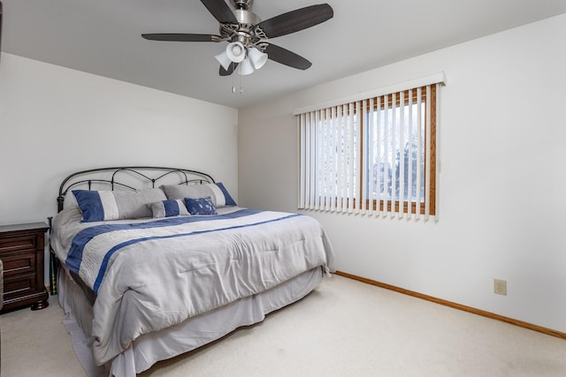 bedroom with ceiling fan, baseboards, and light colored carpet