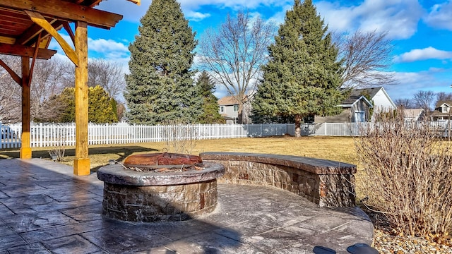 view of patio with an outdoor fire pit and a fenced backyard