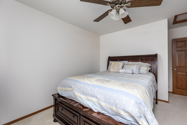 bedroom with a ceiling fan, light colored carpet, and baseboards