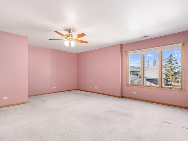 empty room featuring visible vents, a ceiling fan, baseboards, and carpet floors