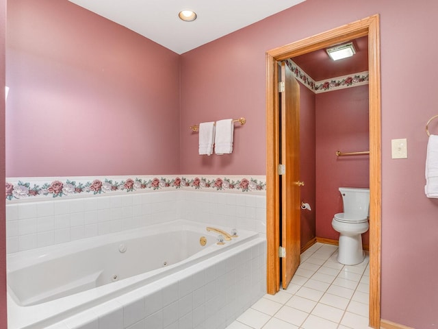 full bath featuring tile patterned floors, toilet, and a tub with jets