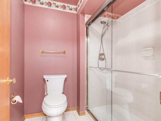 full bathroom with baseboards, toilet, a shower stall, and tile patterned flooring