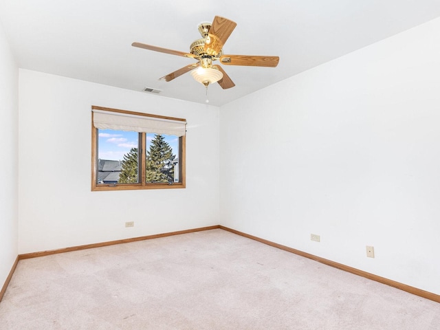 empty room featuring baseboards, visible vents, and carpet floors